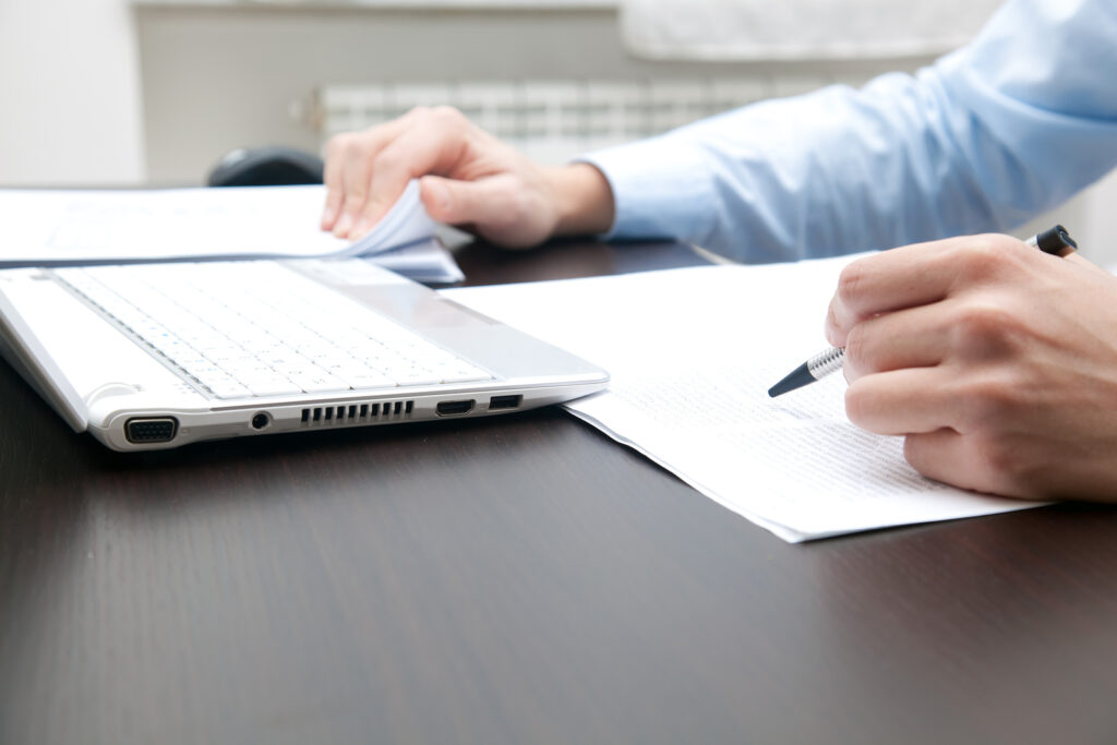 Closeup of a businessman's hands while writing some documents