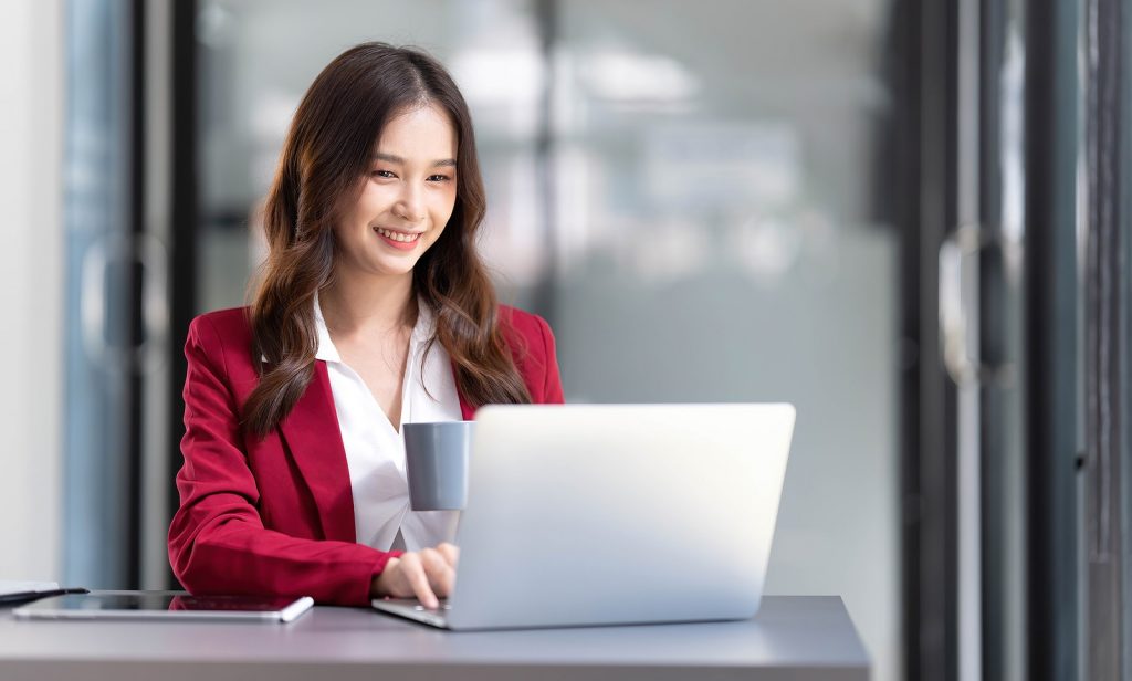 Portrait Of Smiling Beautiful Business Asian Woman In Pink Suit