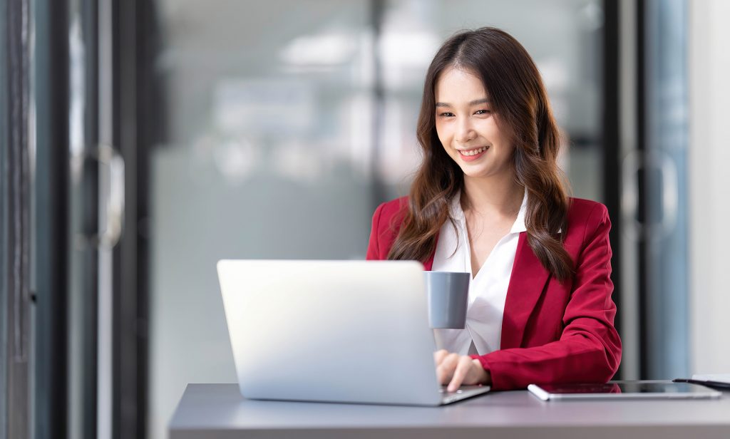 Portrait Of Smiling Beautiful Business Asian Woman In Pink Suit