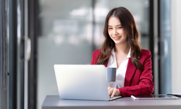 Portrait Of Smiling Beautiful Business Asian Woman In Pink Suit