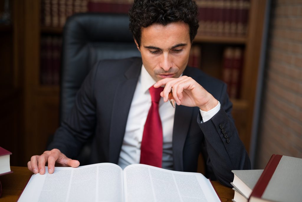 Portrait of a businessman reading a book