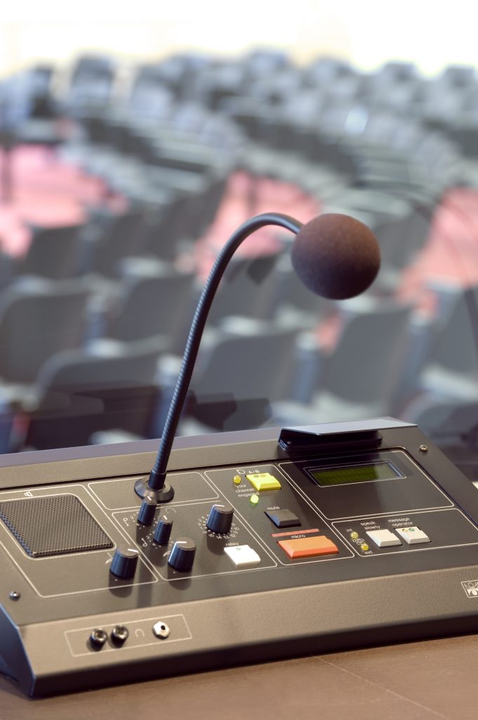 Microphone and switchboard in interpretors booth of a conference