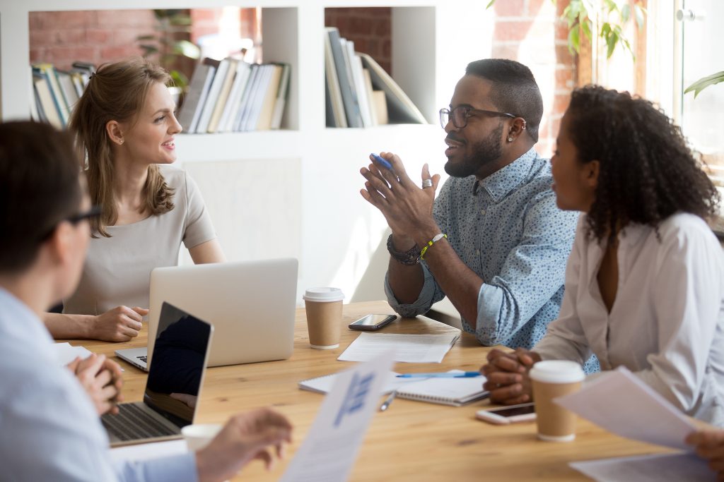African Male Employee Speaking Sharing Ideas At Diverse Team Mee