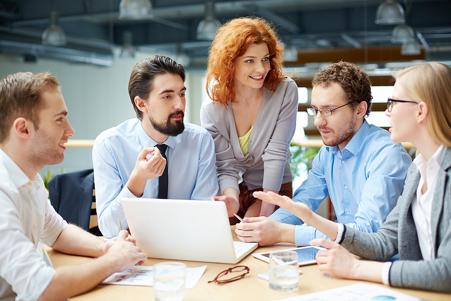 Businesspeople discussing the company???s development at the mee